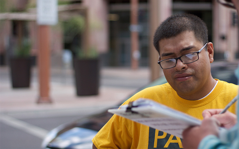 Jose Barboza, a volunteer for Promise Arizona, works to get people registered to vote.