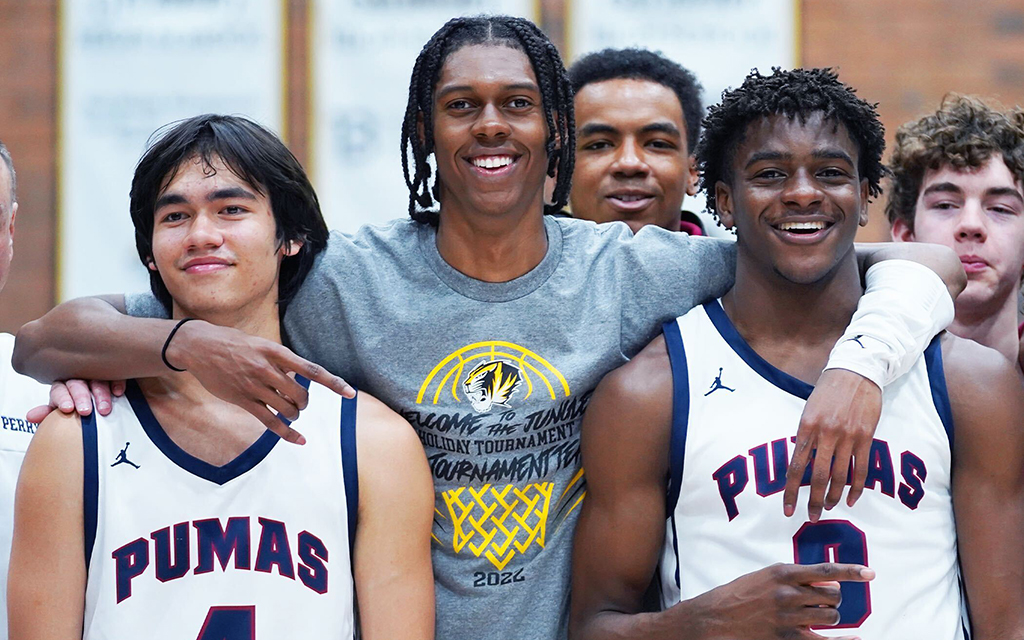 Perry's Jonas Cederlind, left, Cody Williams, and Ben Egbo celebrate winning the Welcome to the Jungle tournament to open the season. The Pumas outscored opponents 317-188 in four games. (Photo by Adrian Chandler/Cronkite News)