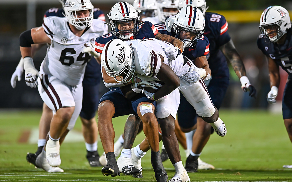 Caption 1: Arizona Wildcats safety Dalton Johnson is emerging as a key player in the Arizona Wildcats' revitalized defense through the first three games of the season. (Photo by Kevin Langley/Icon Sportswire via Getty Images)