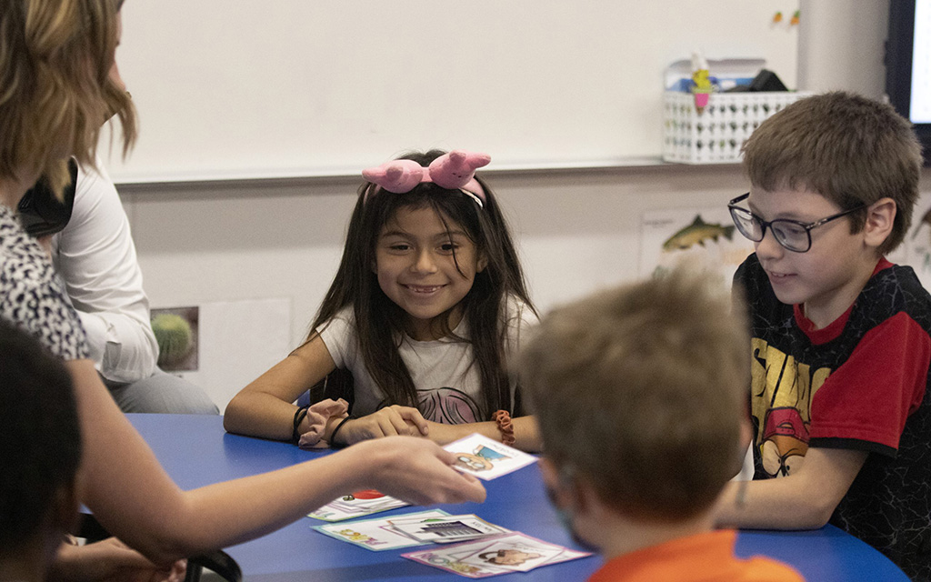 The annual Strategic School Staffing Summit, run by Arizona State University's Mary Lou Fulton Teachers College earlier this month, highlighted a collection of potential solutions to teacher staffing issues across the state. In this 2022 file photo, students work with a teacher at Encanto Elementary School in Phoenix. (File photo by Sophie Oppfelt/Cronkite News)
