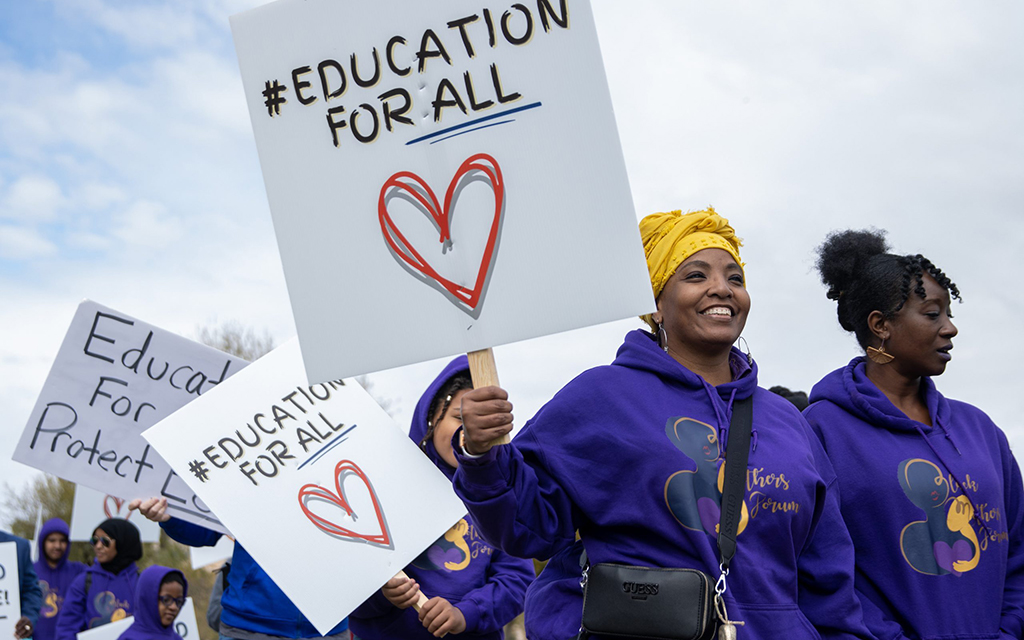 Nyeshua Miller, a teacher at a Black Mothers Forum “microschool,” joins other forum members and marchers who support Empowerment Scholarship Accounts, known as ESAs or school vouchers, in Phoenix in March 2023. Common Sense Institute Arizona has released a report contending that though public school enrollment is in decline, the ESA program may not be solely to blame. (File photo by Emily Mai/Cronkite News)