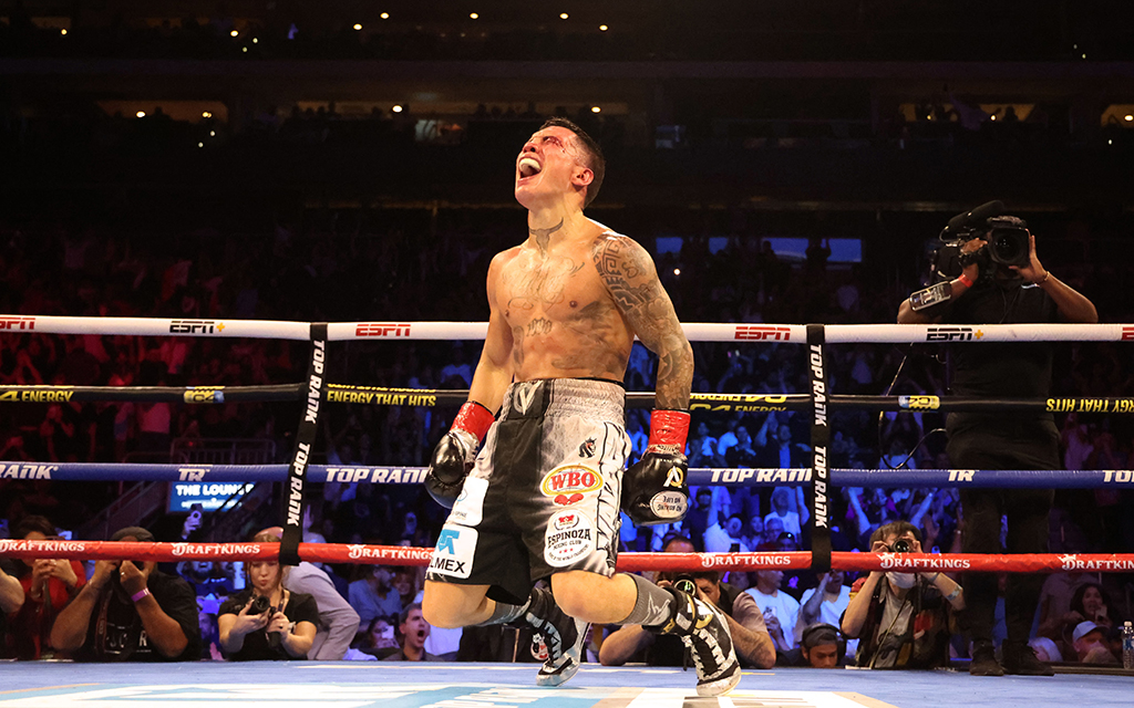 Oscar Valdez falls to his knees in celebration after his seventh round TKO over Liam Wilson Friday at Desert Diamond Arena (Photo by Joe Eigo/Cronkite News)