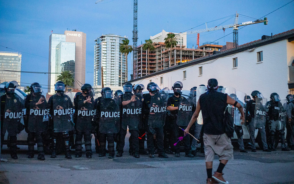 In this May 2020 file photo, Phoenix police officers confront a protester. Protests erupted across the country in 2020 over the death of George Floyd, a Black man, at the hands of a Minneapolis police officer. (File photo by Blake Benard/Special for Cronkite News)