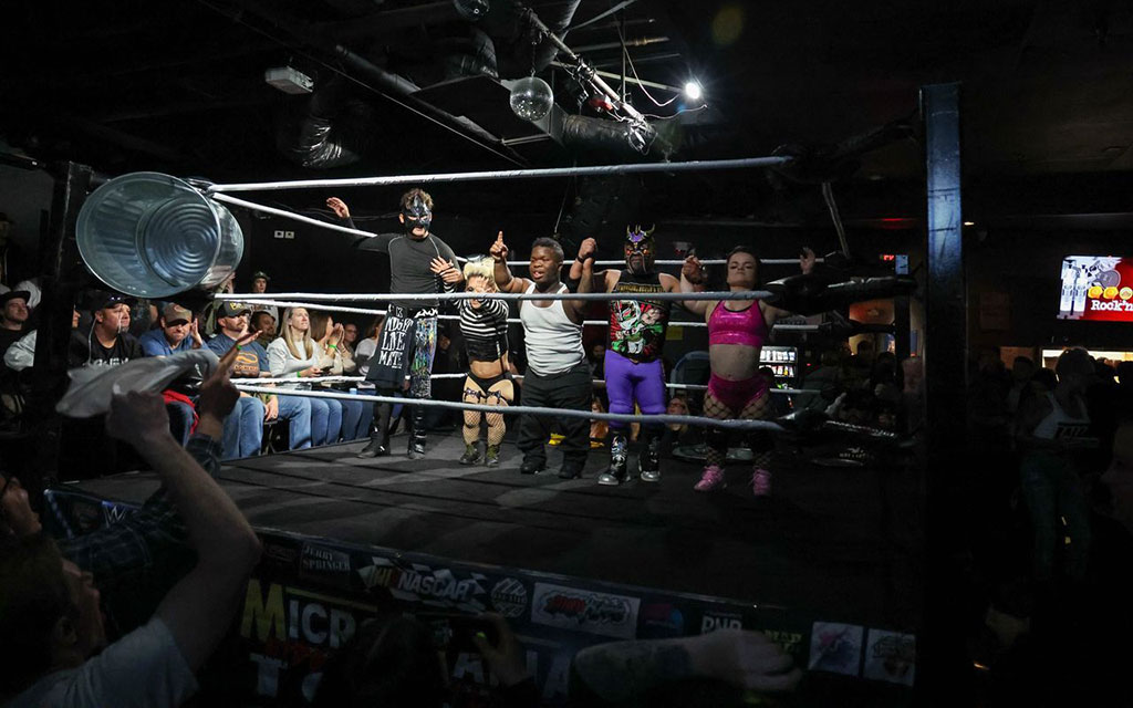 The wrestlers line up to be greeted by the crowd, which delivers a combination of cheers and boos. (Photo by Reece Andrews/Cronkite News)