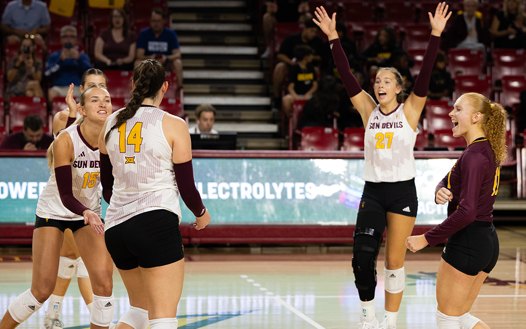 Jillian Neal and teammate volleyball players in "SUN DEVILS" uniforms celebrating on the court.
