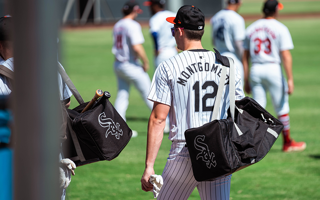 Colson Montgomery walks out onto field with his baseball bag around his shoulder.