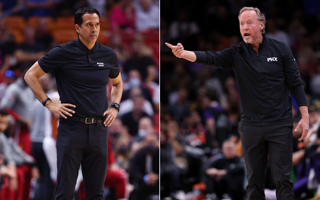 Erik Spoelstra and Mike Budenholzer on a court, each in black attire, with team logos "MIAMI HEAT" and "PHX."