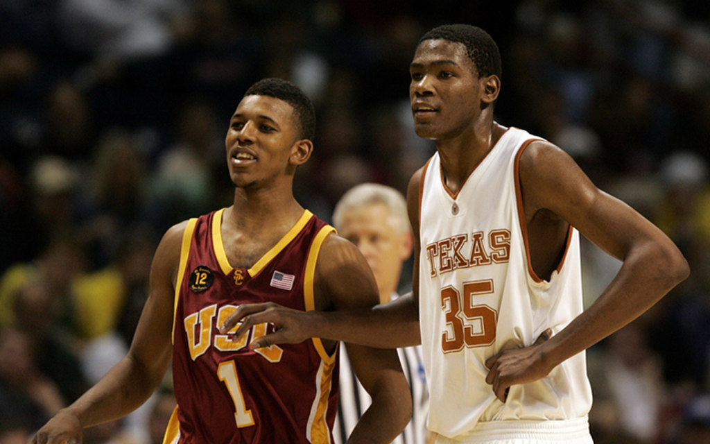 Two basketball players from USC and Texas stand side by side on the court.