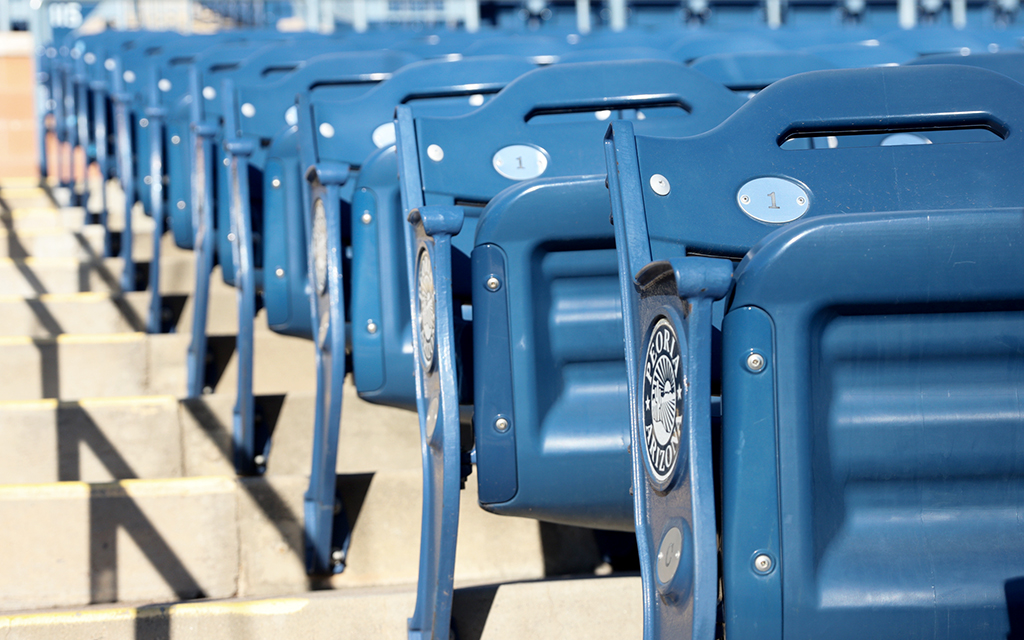Blue stadium seats in a row, each marked with the number "1."