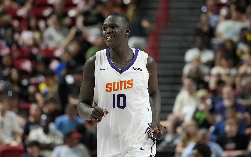 Khaman Maluach wearing a "Suns" jersey with the number "10" on a court, with a blurred crowd in the background.