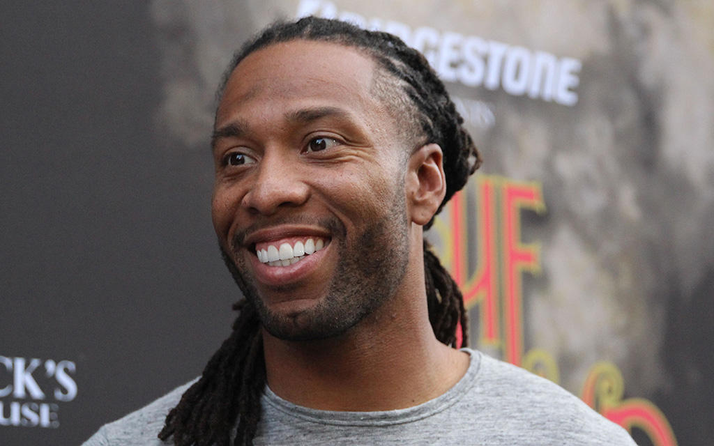 Former Arizona Cardinals wide receiver Larry Fitzgerald smiles at an event.