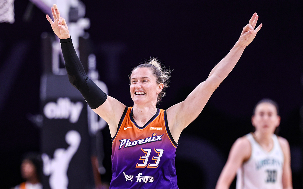 Sami Whitcomb holds up three fingers on each hand after scoring a three pointer against the New York Liberty.